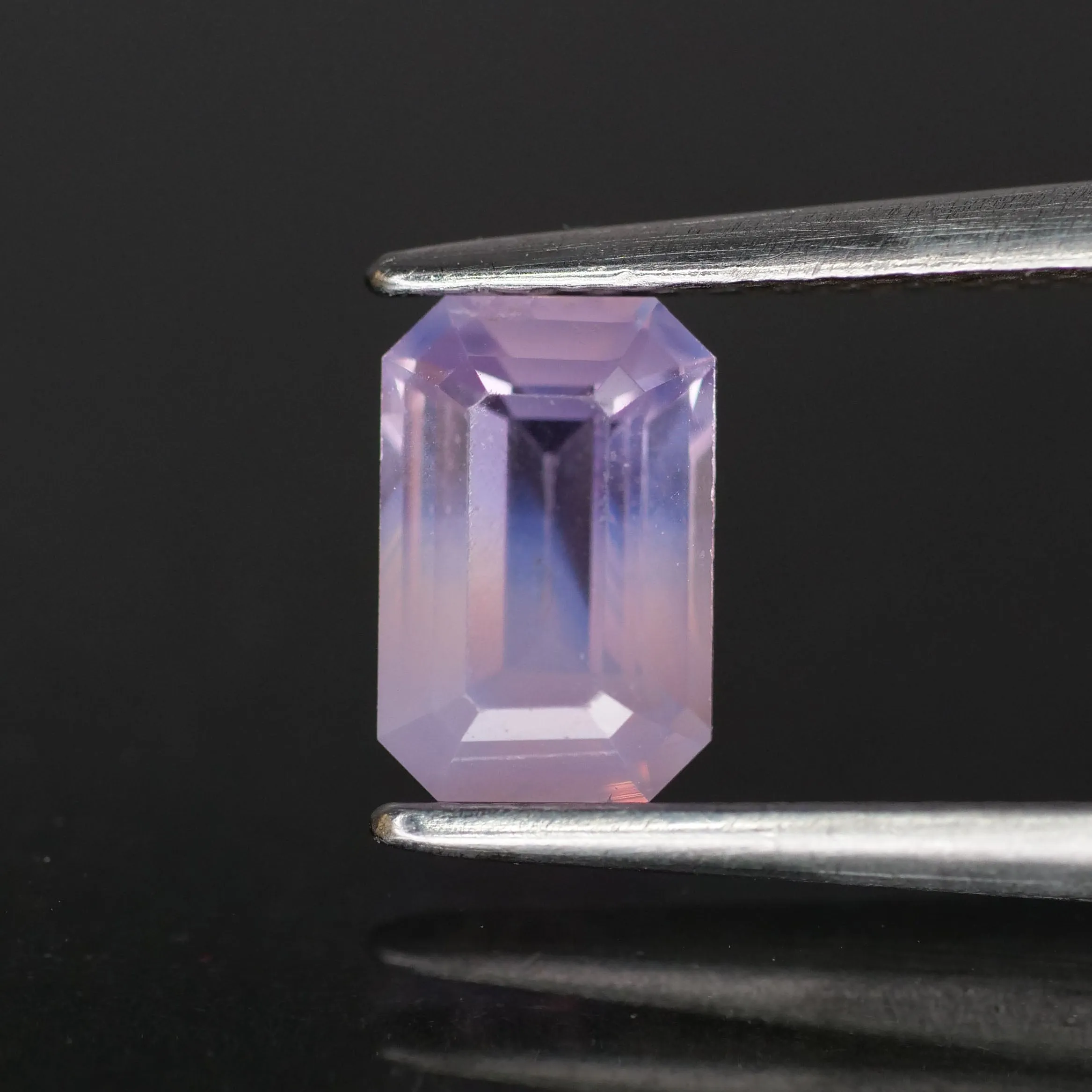 Sapphire opalescent | natural purplish pink, emerald cut 6.6x4.3mm, VS *0.9ct