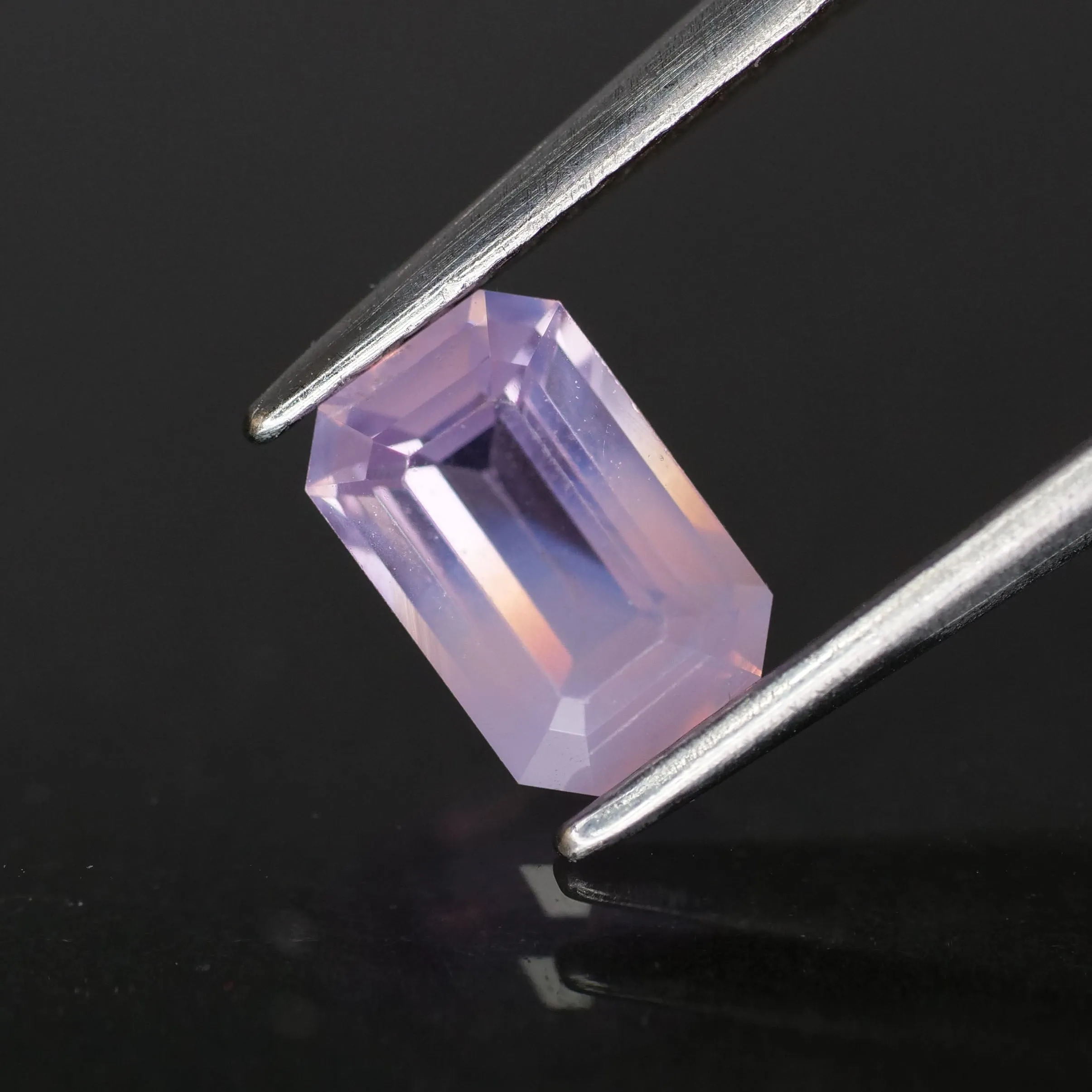 Sapphire opalescent | natural purplish pink, emerald cut 6.6x4.3mm, VS *0.9ct